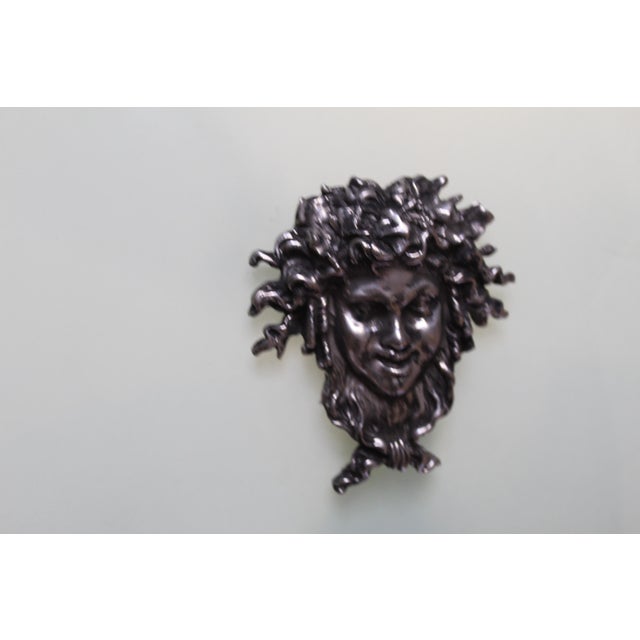 A Large size of Glass shade designed with four cast Bronze man's faces applied . The hardware is finished in Hi-polished...