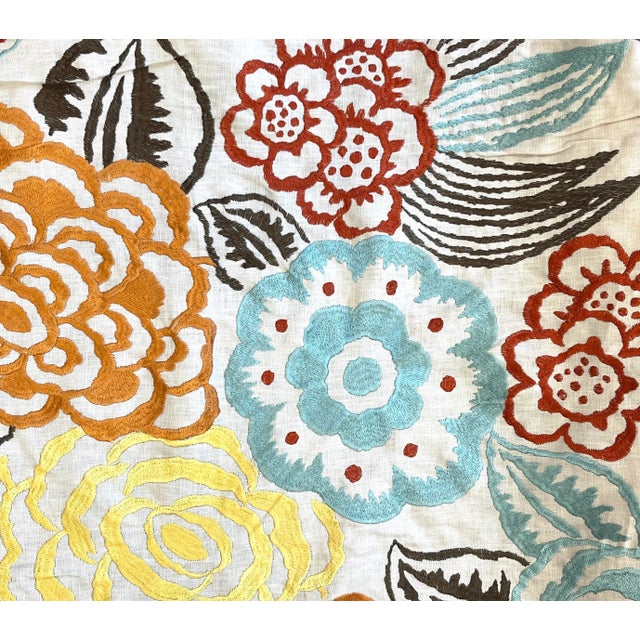 Lee Jofas Nolita fabric. An Ivory Linen ground, the flowers are embroidered in turquoise, yellow, orange, rust and...