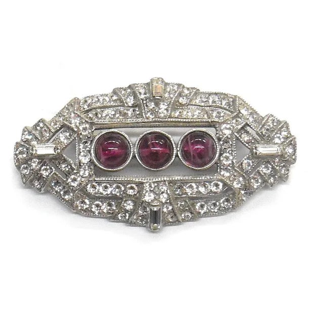 Silver plated brooch with clear crystals and purple stones 1 1/4" x 2 1/4"