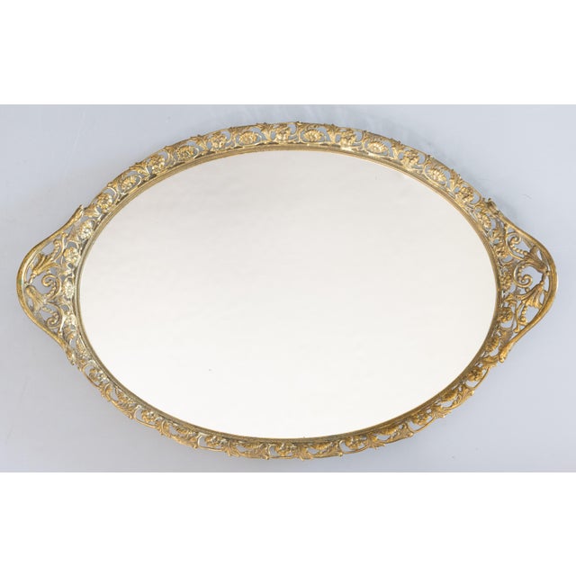 A stunning vintage French gilt ormolu oval mirror vanity dresser or bar tray, circa 1950. This beautiful tray is a nice...