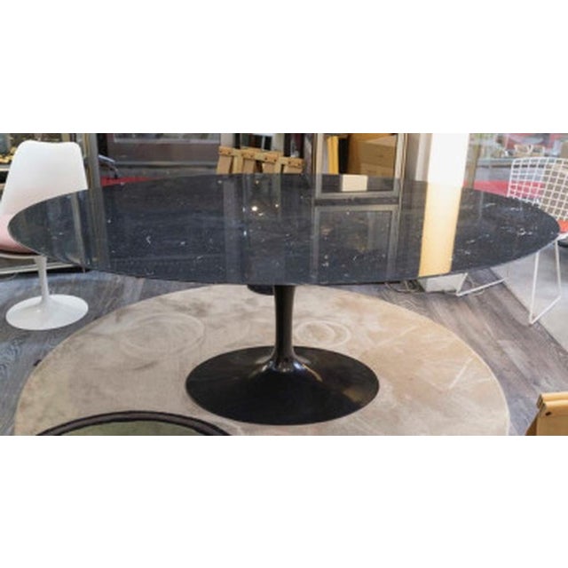 Eero Saarinen & Knoll International: "Tulip" Table, Marquina Marble and Black Rilsan. Table for 8 with an oval top in...