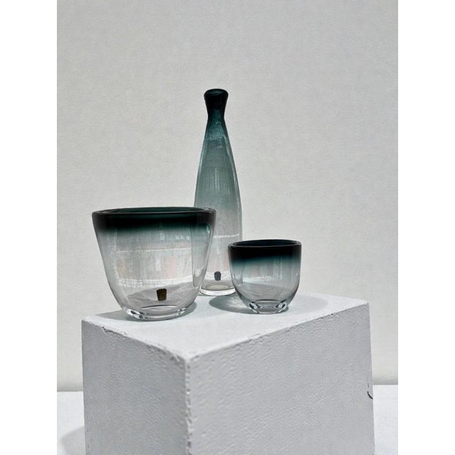 Elegant Swedish modern glass set designed by Bengt Orup for Johansfors, circa 1960, from the “Tona” series. The group...