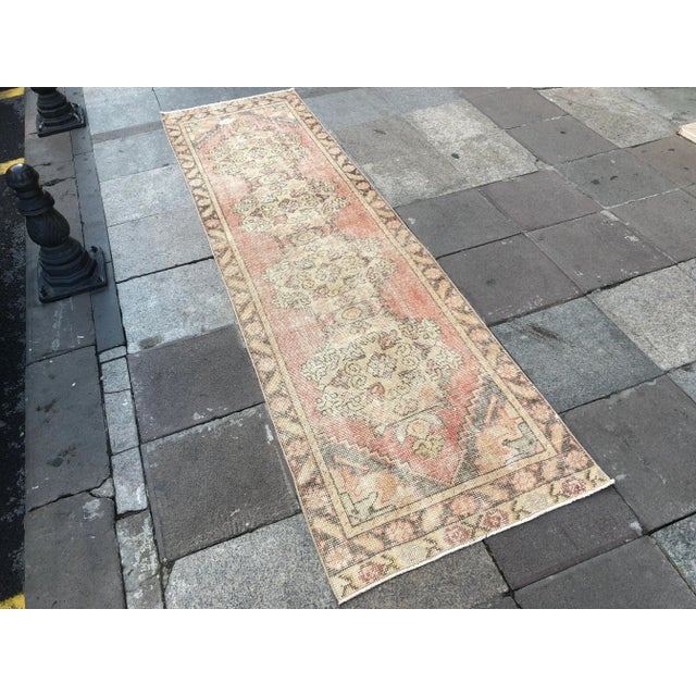 This is a vintage Turkish Oushak rug from the 1960s. The piece was hand-knotted.