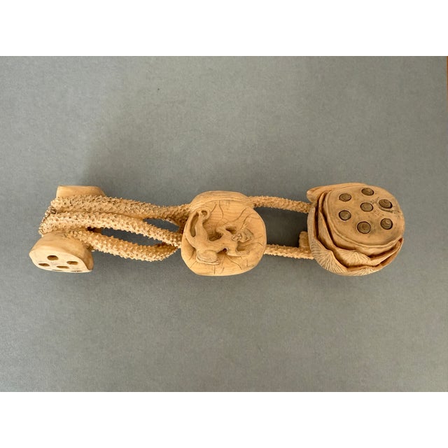 Symbolizing purity, longevity and good fortune, this intricate carving of a lotus is most likely cliff cypress. Beautiful...