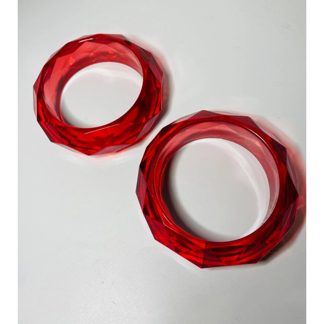 This is part of Chairish’s Costume Jewelry assortment. Bold bright Raspberry Red Lucite bracelets from the 1950s