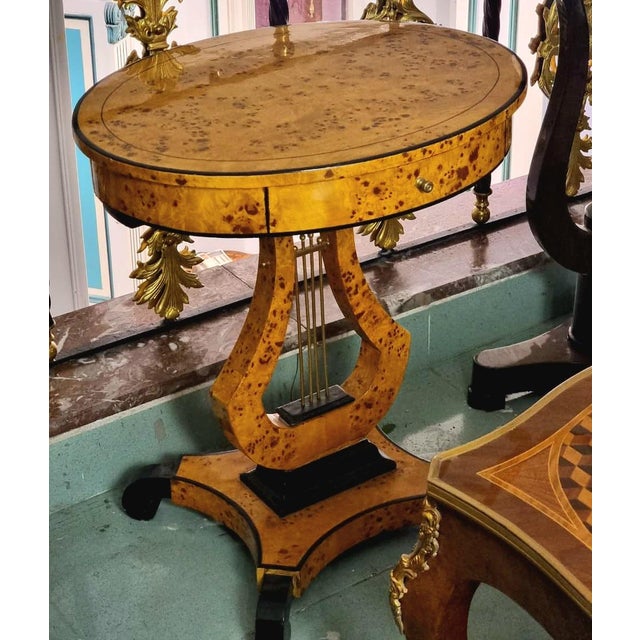 Bring a distinctive touch of European elegance to your interior with this French Empire-inspired side table, featuring a...