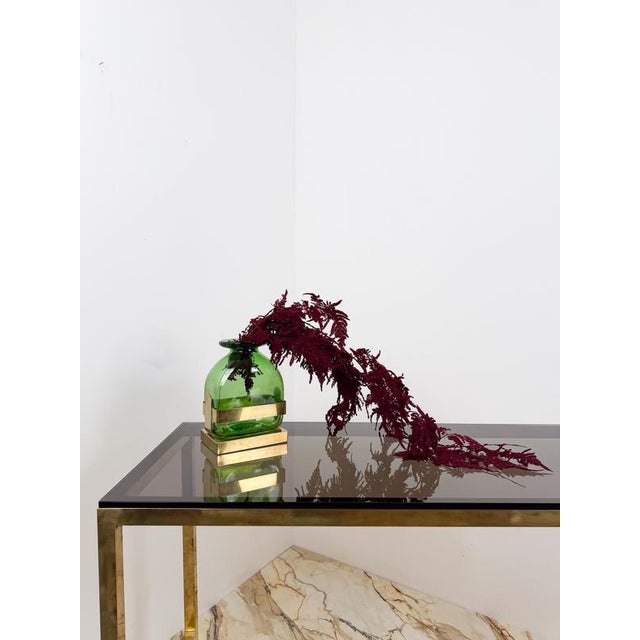 Mid-20th-century vase that perfectly blends two excellences of Made in Italy: Empoli green glass and Italian design....