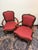 A charming pair of fruitwood armchairs, each featuring a beautifully carved foliate top rail above an upholstered back...