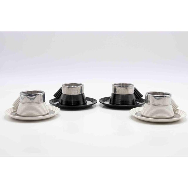 Set of 4 espresso cups with plates designed by Carlo Giannini in 1970s. Stainless steel (marked inox 18/10) for the cup...