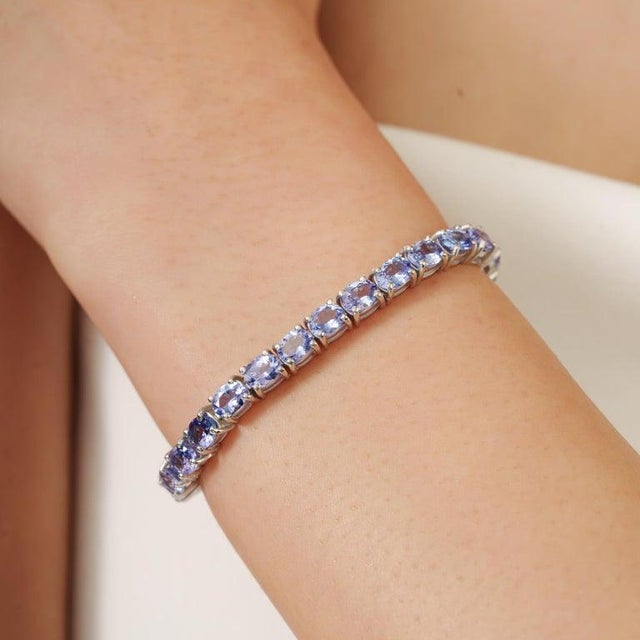 This elegant tennis bracelet is crafted in 925 sterling silver and beautifully set with 35 natural Tanzanite gemstones...