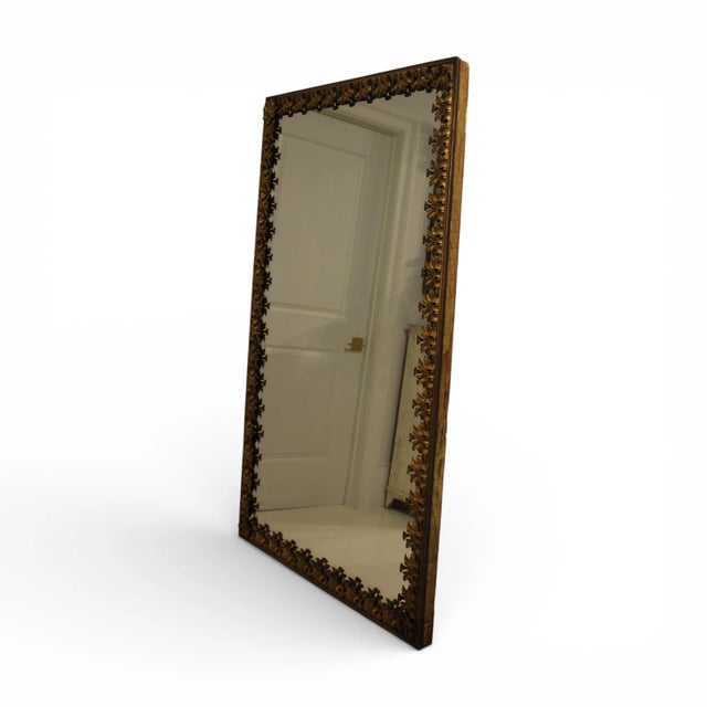 A 19th-century French antique brass bistro floor mirror, featuring a tall, heavily ornaments frame crafted in gold...
