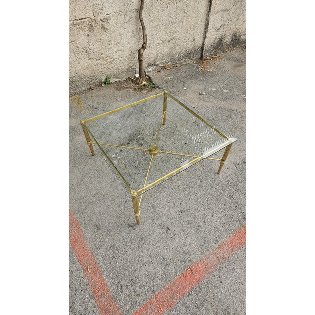 Low sofa tables made entirely of brass with glass top.