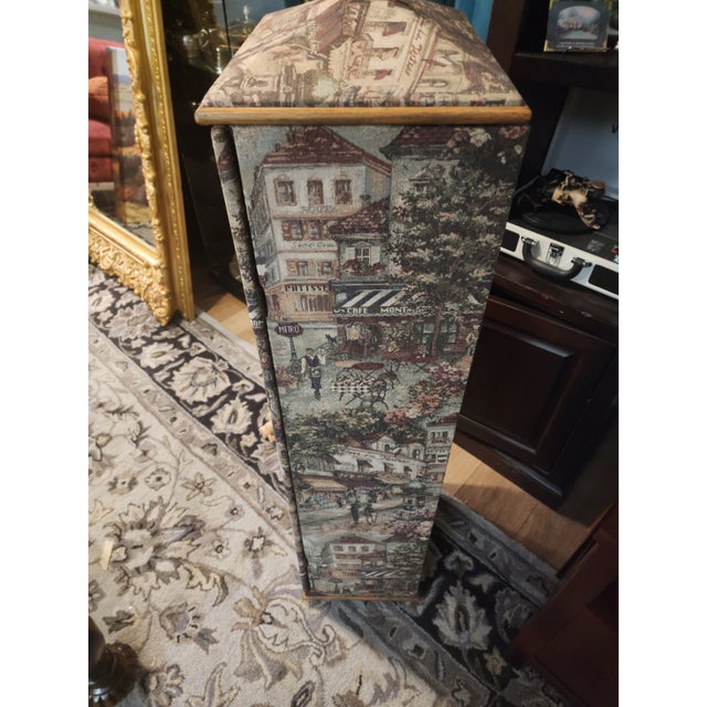 Add a touch of European elegance to your home with this unique vintage tapestry-covered cabinet. The exterior features...