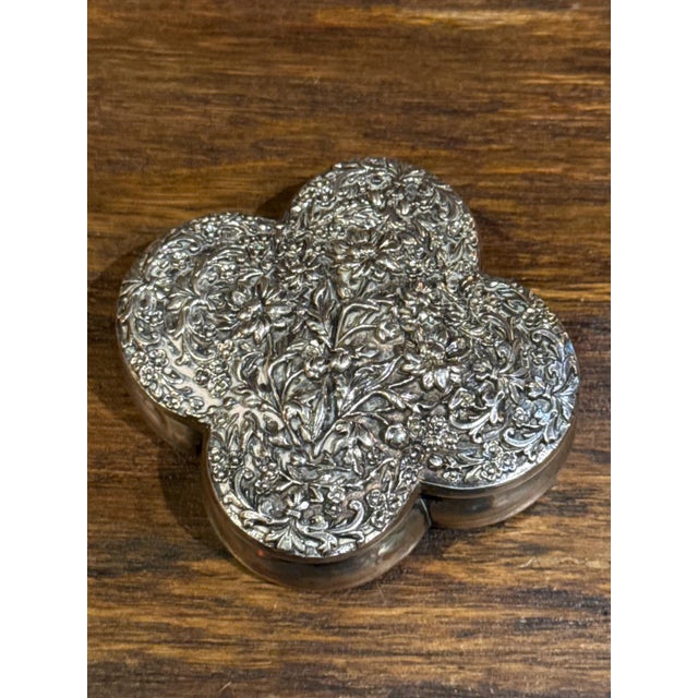 Sterling silver box in a quatrefoil shape. Heavily decorated lid with a floral repousse design. Gorgeous. Stamped sterling...