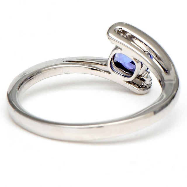 A contemporary approach to a classic design, this cushion blue tanzanite and diamond ring is set in 14-karat white gold....