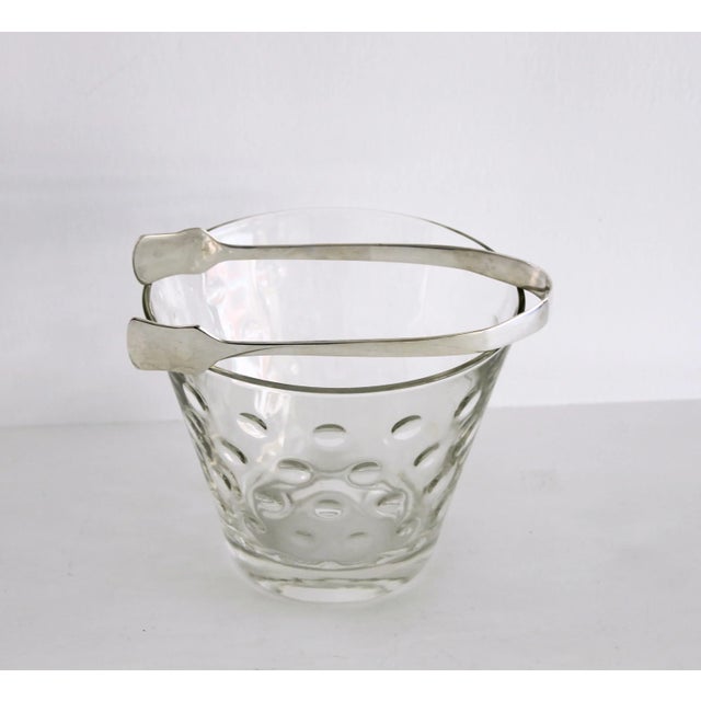 Small MCM crystal ice bucket attributed to Hazel Atlas and silver plated ice tong set. Fits well on bar cart, bar top or...