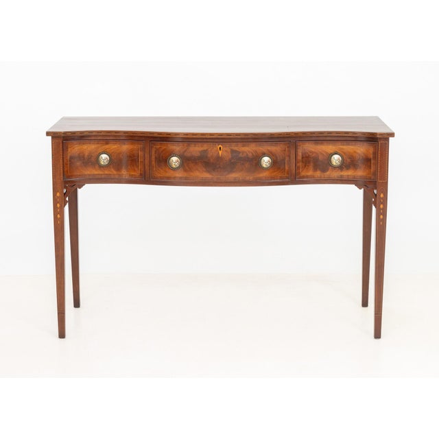 Sheraton Style Marquetry Inlaid Flame Mahogany Serpentine Hall Table, the three drawers with courting scene framed pulls,...