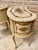Two elegant bedside or side tables in solid wood, Louis XV style painted in light beige with floral touches. Made of...