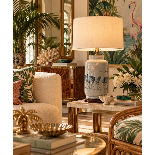 Beautiful vintage Hollywood Regency-style ceramic table lamp featuring an elegant Asian-inspired design with a group of...
