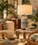 Beautiful vintage Hollywood Regency-style ceramic table lamp featuring an elegant Asian-inspired design with a group of...