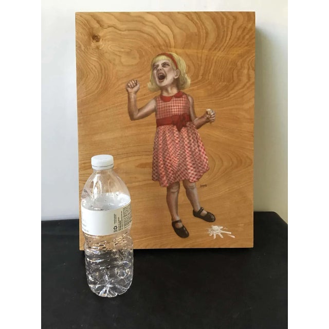 Painting on board of a girl dropping her ice cream.