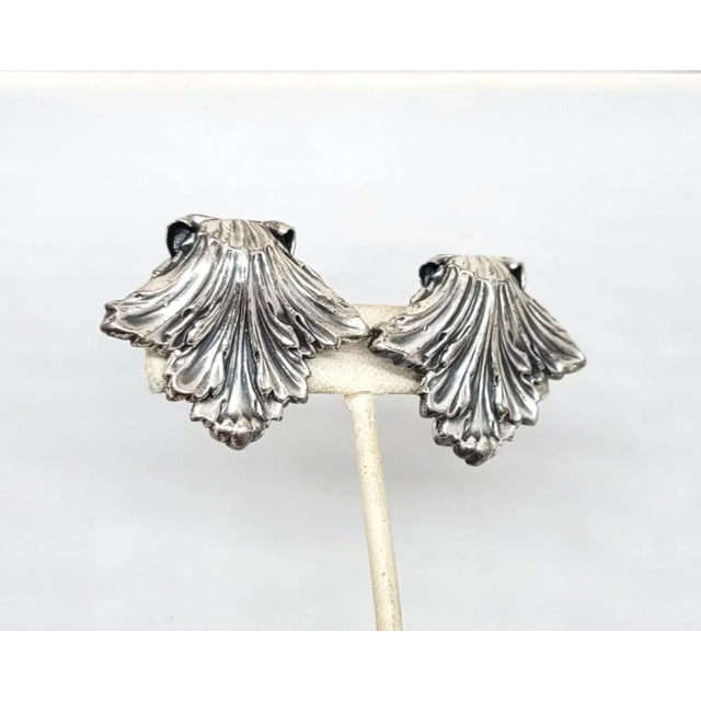 This is part of Chairish’s Costume Jewelry assortment. Silvertone textured leaf clip back earrings. Marked "NAPIER PAT....