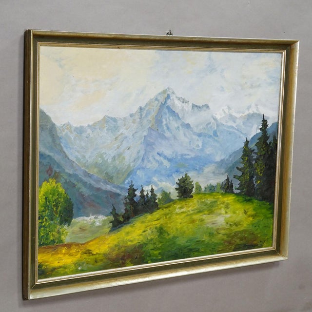 Alpine Landscape Painting with Meadow, Trees and Mountains A large magnificent landscape painting in a golden wooden...