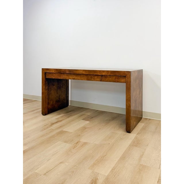 This rare vintage desk by Hekman is a striking example of mid-century modern craftsmanship, showcasing rich burlwood...