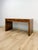This rare vintage desk by Hekman is a striking example of mid-century modern craftsmanship, showcasing rich burlwood...