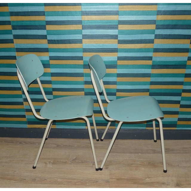 Set of two Industrial-style chairs from the Netherlands White metal frame, black floor protectors Backrest and seat are...