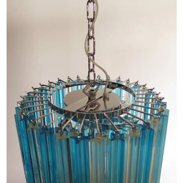 Fantastic vintage Murano chandelier made by 86 Murano crystal trasparent and blue prism in a nickel metal frame.The shape...