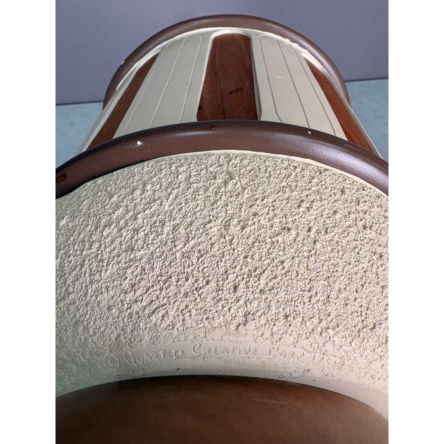 Mid Century Modern ceramic jug table lamp. Cream colored popcorn textured and round wood paneling with some darker brown...