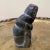 An Inuit style carved by hand of dark soapstone .The sculpture is numbered on the bottom 779