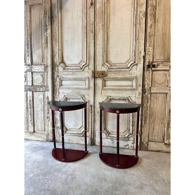 Pair of mahogany console tables/bedside tables with crescent-shaped green marble tops. The columns are adorned with rings....