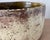 A substantial studio pottery bowl with a softly irregular cylindrical form and a richly contrasting glaze treatment. The...