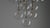 An arrangement of thirteen glass globes suspended from a discus of brass forms a serene ceiling constellation. The...
