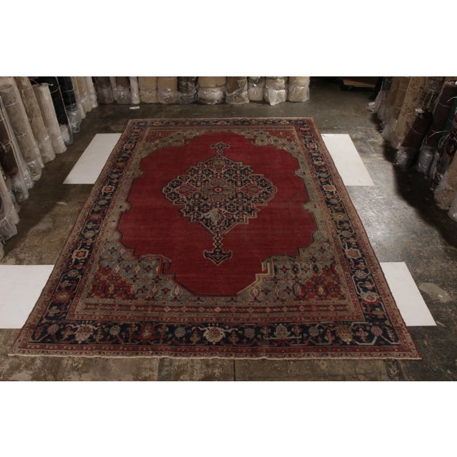 Handmade with hand-knotted wool originating from Turkey circa 1890-1900, this item is an antique rug enjoying an influence...