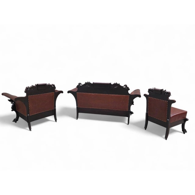 Antique Renaissance Revival Carved Walnut Parlor Suite Newly Upholstered in Brown Leather - Set of 3 An impressive antique...