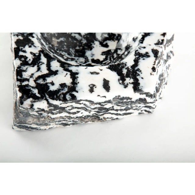 A striking zebra stone mineral vide-poche, carved from a richly patterned natural stone exhibiting bold, high-contrast...