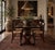 This antique wooden dining table features a sculptural trestle base with pierced pedestal supports, exposed joinery...