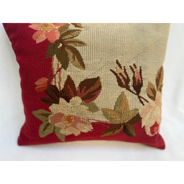 Decorative pillow upholstered in richly woven 19th century Aubusson tapestry, adorned with an elegant floral motif. A...