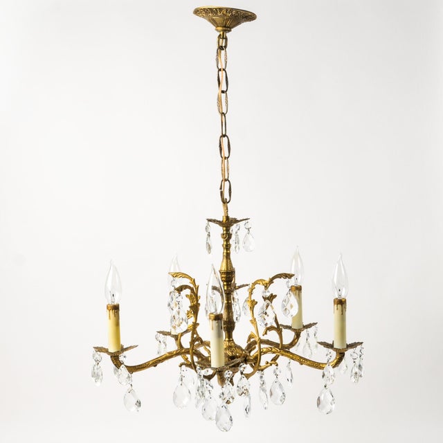 Adorable five arm Spanish brass and crystal chandelier with all the classic charm of ornate brass arms and bobeches and...