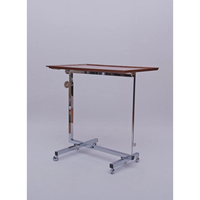 Variett Bremshey side table. The table is on wheels. Dimensions: HxWxD: 67 to 97.5 cm x 74 x 40 cm HxWxD when folded: 82 x...