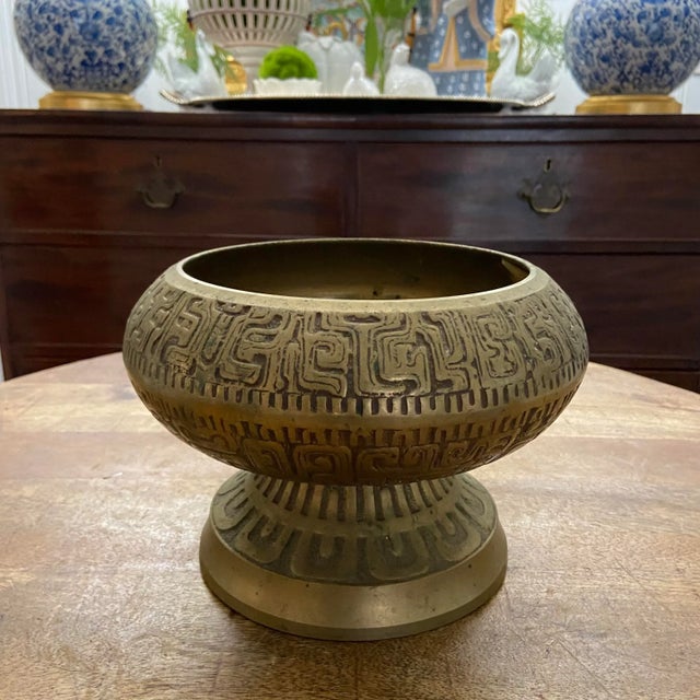 Classic mid century brass pedestal cachepot with Asian influence and modern design. Nicely-aged brass finish and an...