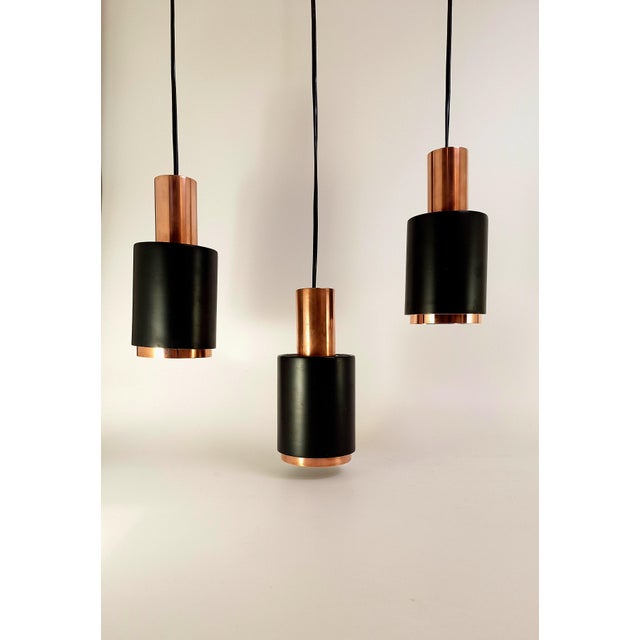 “Tunika” pendant lamp designed by Johannes Hammerborg for Fog & Mørup, Denmark in the 1960s. This sculptural three-light...