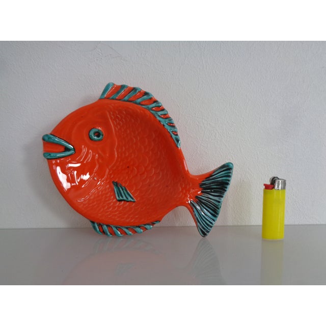Italian ceramic ashtray in the shape of a fish, dating from the 1960s, in very good condition. The dark spots are not damage.