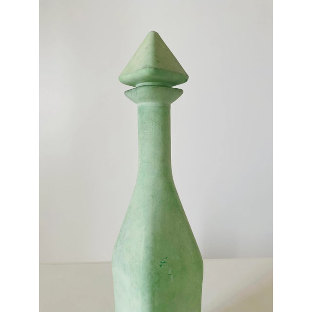Green -colored painted glass bottle.