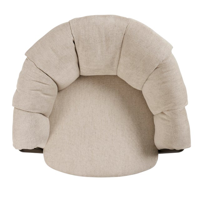 Featuring a form that wraps you in a cocoon-like embrace, the Puffin Dining Chair playfully juxtaposes a generously...