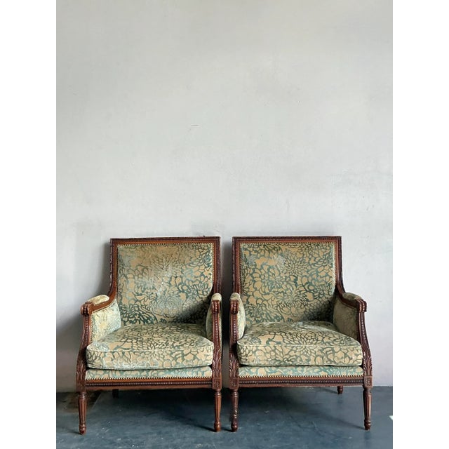 Presenting an exquisite pair of vintage Bergere chairs, embodying the sophisticated elegance and intricate craftsmanship...
