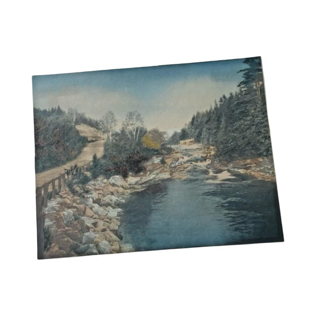 A beautifully presented hand-colored photograph titled A Little River and Mt Washington by Wallace Nutting, one of the...